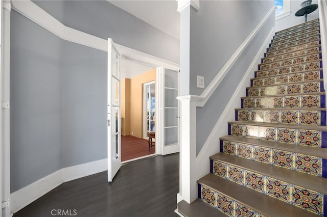 stairs featuring hardwood / wood-style floors