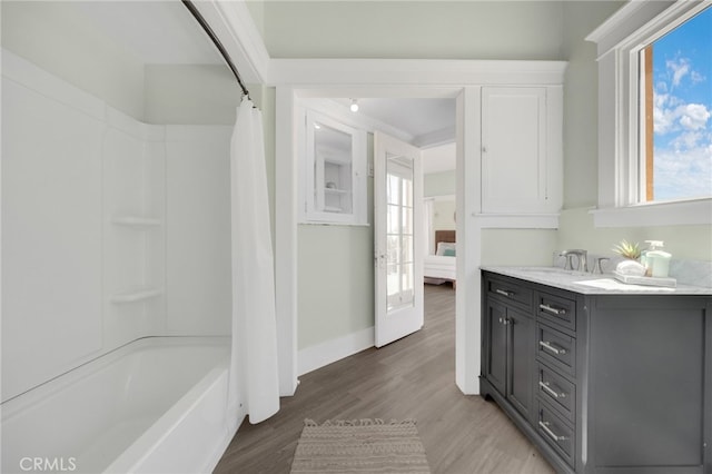 bathroom featuring vanity, hardwood / wood-style flooring, and shower / tub combo with curtain