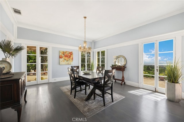 dining room with french doors, ornamental molding, a chandelier, and dark hardwood / wood-style flooring