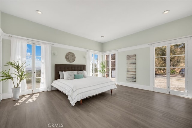 bedroom featuring access to outside and dark hardwood / wood-style floors