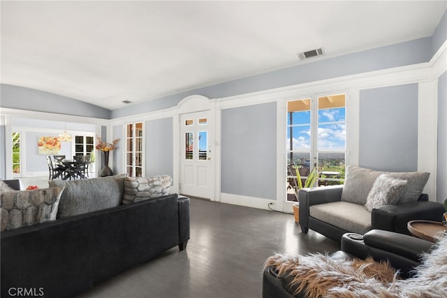 living room featuring vaulted ceiling and dark hardwood / wood-style floors