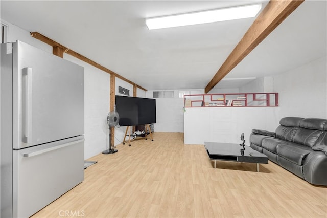 living room featuring wood-type flooring and beamed ceiling