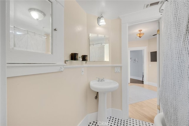 bathroom featuring a shower with curtain and hardwood / wood-style flooring