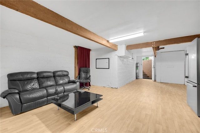 living room featuring light wood-type flooring and beam ceiling