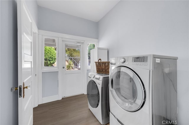 washroom featuring dark hardwood / wood-style floors and washing machine and dryer