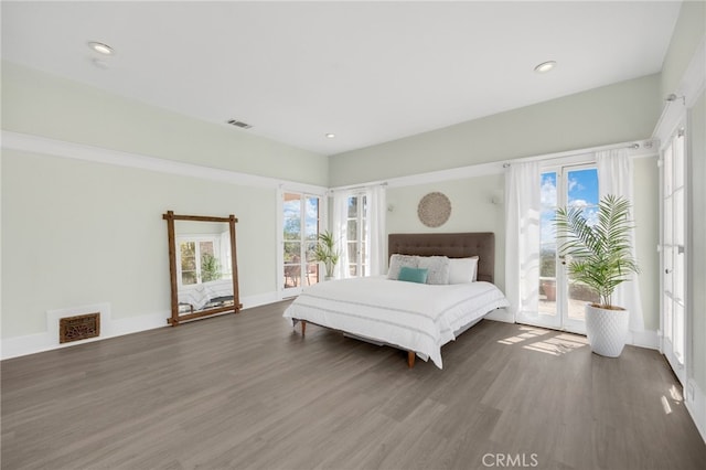 bedroom with access to outside and dark hardwood / wood-style flooring