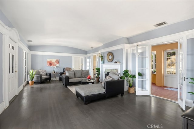 living room with vaulted ceiling and dark wood-type flooring