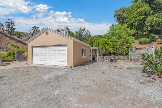 view of side of home featuring a garage