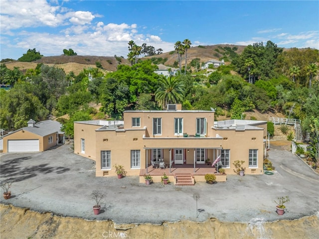 back of property with a garage and an outdoor structure