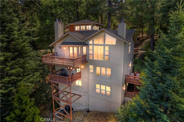 rear view of property featuring a balcony