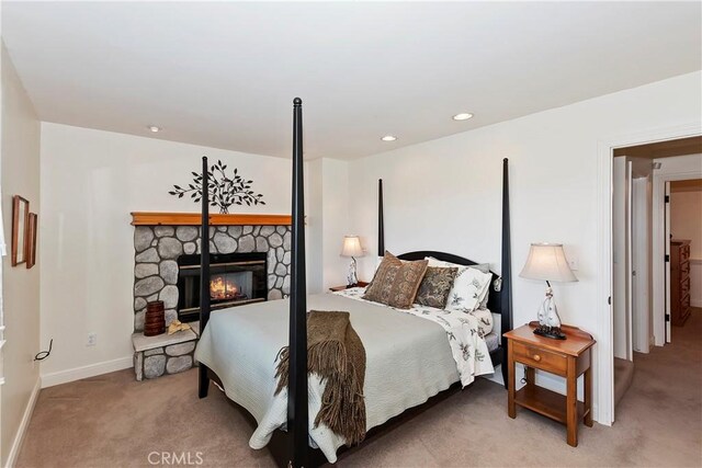 bedroom featuring a fireplace and carpet flooring