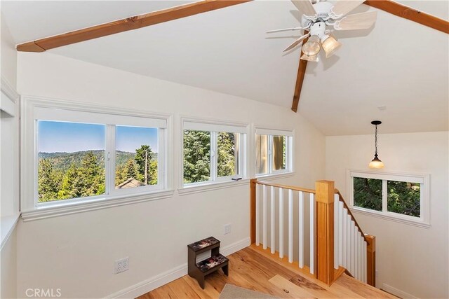 additional living space featuring ceiling fan, vaulted ceiling with beams, and light hardwood / wood-style flooring