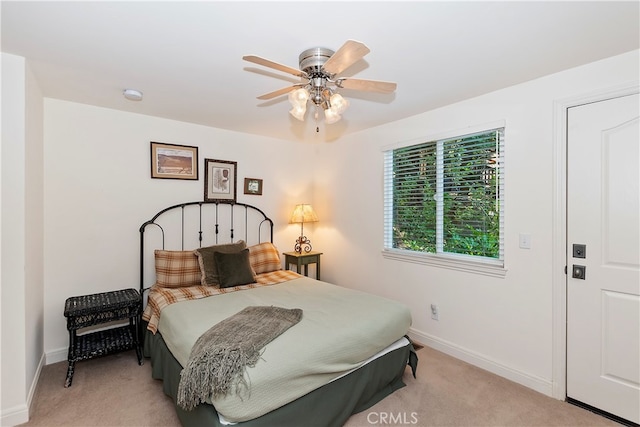 bedroom featuring ceiling fan and light colored carpet