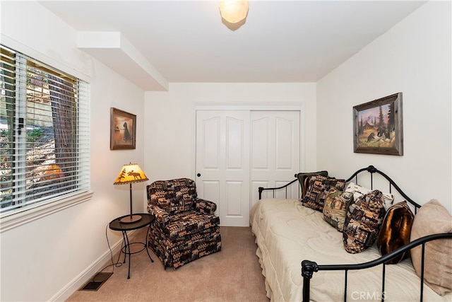 bedroom featuring light carpet and a closet