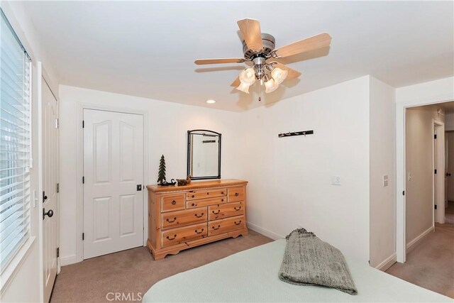 carpeted bedroom featuring ceiling fan