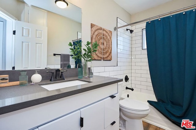 full bathroom with shower / bath combo, hardwood / wood-style flooring, decorative backsplash, vanity, and toilet