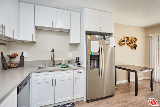 kitchen featuring light hardwood / wood-style flooring, stainless steel appliances, white cabinets, and sink