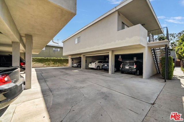 view of home's exterior featuring a balcony and a garage