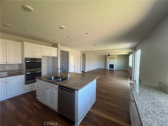 kitchen with ceiling fan, sink, white cabinetry, stainless steel appliances, and dark hardwood / wood-style floors