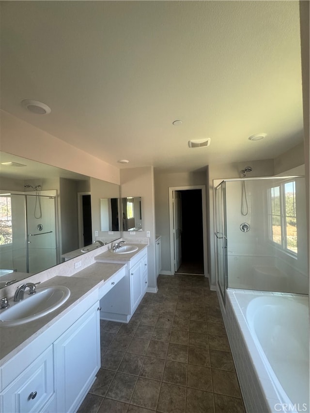 bathroom with tile patterned floors, vanity, shower with separate bathtub, and a healthy amount of sunlight