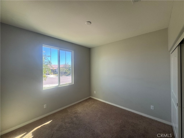 unfurnished room with carpet flooring