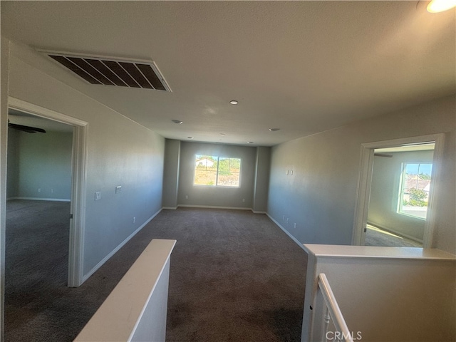 carpeted empty room featuring a wealth of natural light