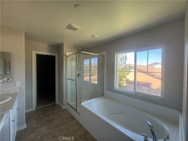 bathroom with vanity and separate shower and tub