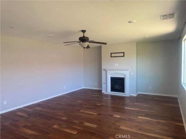 unfurnished living room featuring ceiling fan and dark hardwood / wood-style floors