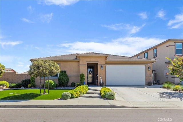 view of front of house with a front yard and a garage