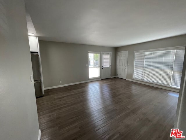 empty room featuring dark hardwood / wood-style flooring