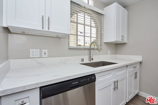 kitchen with dishwasher, light stone counters, sink, white cabinetry, and dark hardwood / wood-style flooring