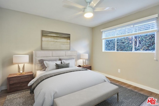 bedroom with hardwood / wood-style floors and ceiling fan