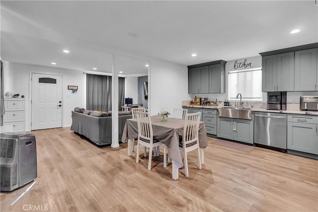 dining space with sink and light hardwood / wood-style floors