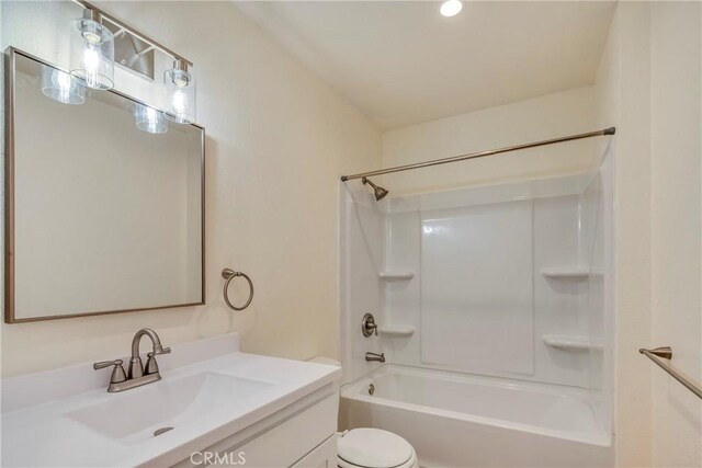 full bathroom with  shower combination, vanity, and toilet