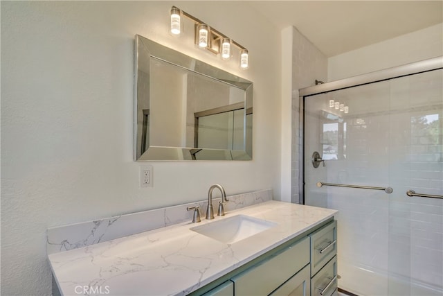 bathroom featuring walk in shower and vanity