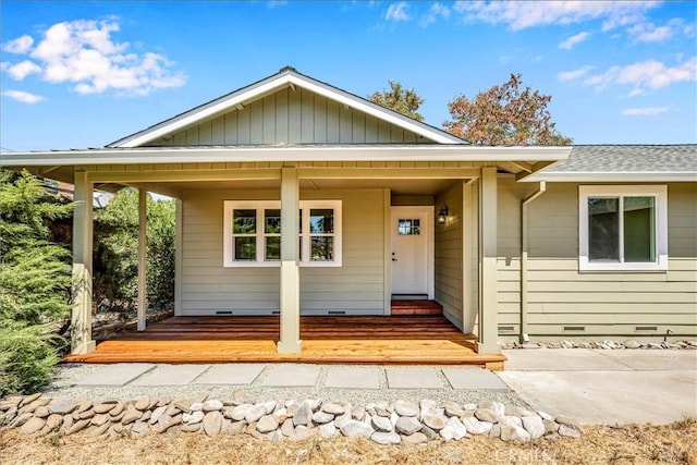 view of front of property featuring a shingled roof, crawl space, and covered porch