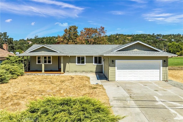 ranch-style home with a garage, driveway, roof with shingles, and covered porch