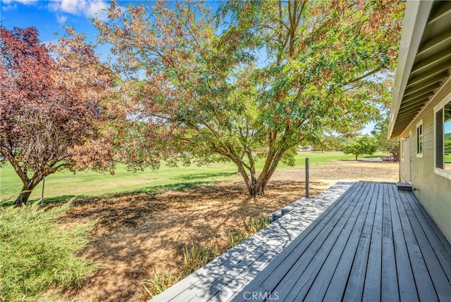 wooden terrace featuring a yard