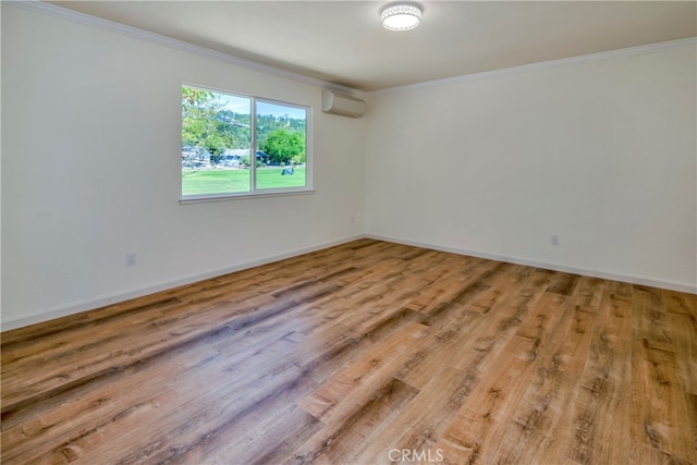 unfurnished room featuring wood-type flooring, crown molding, and a wall mounted air conditioner