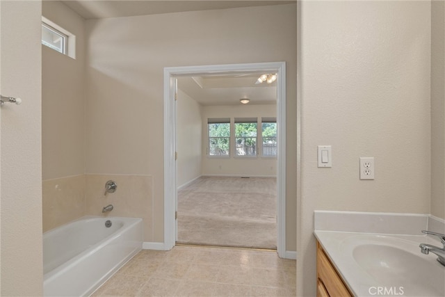 bathroom featuring a washtub and vanity