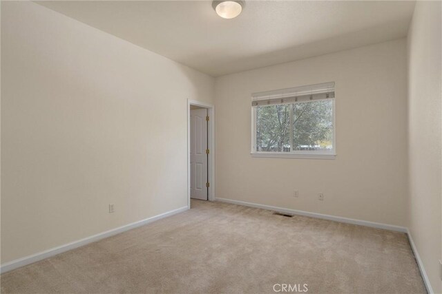 spare room with light colored carpet