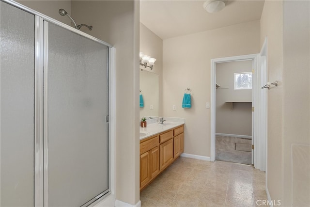 bathroom with vanity and a shower with shower door