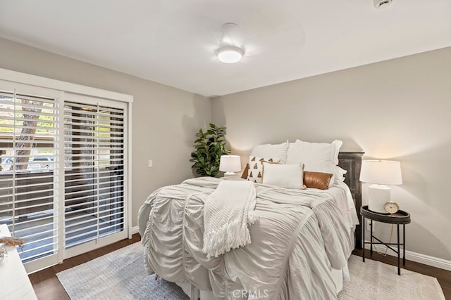 bedroom featuring dark hardwood / wood-style floors, ceiling fan, and access to exterior