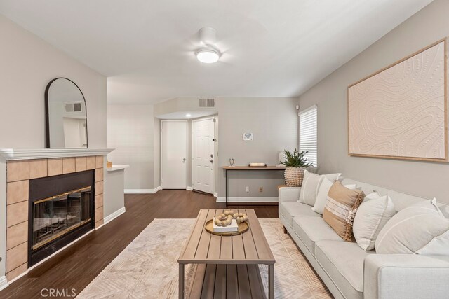 living room featuring a fireplace and dark hardwood / wood-style flooring