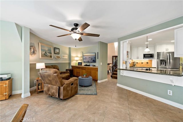 tiled living room featuring ceiling fan