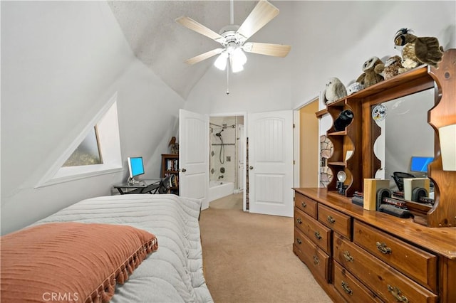 carpeted bedroom with ceiling fan, ensuite bathroom, and vaulted ceiling