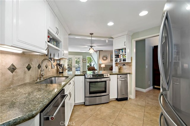 kitchen with kitchen peninsula, sink, white cabinets, and stainless steel appliances