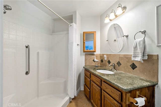 bathroom featuring vanity, a shower with curtain, backsplash, and tile patterned floors