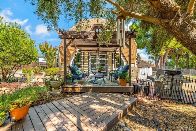 wooden deck featuring a pergola and a grill