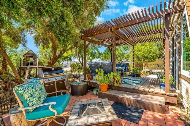 view of patio / terrace featuring area for grilling, a pergola, a fire pit, and a deck